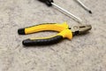 Hand tool yellow pliers close-up part screwdriver blurred background industrial design decoration web design Royalty Free Stock Photo