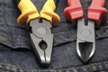 Hand tools master electrician side cutters pliers metal part on a blue background close-up