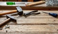 Hand tools old used, hammer, sledgehammer plincers and nail on wood, work bench table Royalty Free Stock Photo