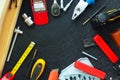 Hand tools: planer, pliers, drills, tape measure, screws and boards on a black texture background. Royalty Free Stock Photo