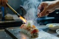 hand torching a piece of aburistyle sushi Royalty Free Stock Photo
