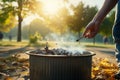 Hand tosses cigarette into metal trash, park cleanliness