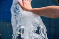 Hand touch the fountain. A stream of water from the fountain is touched by hand Royalty Free Stock Photo