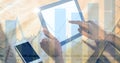 Hand touching digital tablet with graph overlay Royalty Free Stock Photo