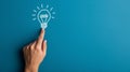 A hand touching a drawn lightbulb symbolizing an idea on a teal background.. AI generated Royalty Free Stock Photo