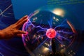 hand touching electric ball beautiful light