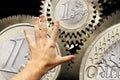 Hand touching euro coin gears Royalty Free Stock Photo