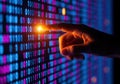Hand touching glowing binary code on digital display screen Royalty Free Stock Photo