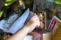 Hand touching Hamper with various products wrapped in gold colour for Hari Raya Aidilfitri.