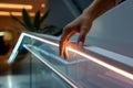 hand touching an ledlit handrail in a modern setting Royalty Free Stock Photo