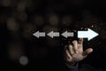 Hand touching light blue arrow which opposite direction with white arrow. Disruption and different thinking for discovery new Royalty Free Stock Photo