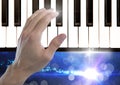 Hand Touching Piano keys with sparkling lights Royalty Free Stock Photo