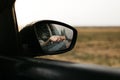 Hand touching rain drops. Mirror seen through the glass. Wet car window. Close up rain drop. Car view see the mirror. Rainy day Royalty Free Stock Photo