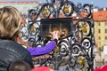 Hand touching saint Jan Nepomuk on Charles Bridge in Prague, Czech Republic. Making wish in Prague. Royalty Free Stock Photo