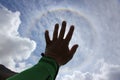 Hand touching the sun. Fantastic beautiful sun halo phenomenon