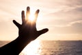 Hand touching sun during sunset background Royalty Free Stock Photo