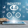 Hand touching tablet displaying Industry 4.0 icons and text Cloud Big Data technology Royalty Free Stock Photo