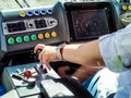 The hand of the tram driver switches the speed in the cab