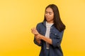 Hand trauma. Portrait of girl in denim shirt touching sore wrist, massaging inflamed place to relieve pain