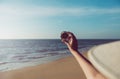 Hand traveler woman holding compass at the beach,Navigation for travel,Close up