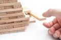 Hand try to take off piece of wooden brick of construction game Royalty Free Stock Photo