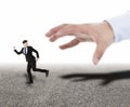 hand trying to catch running businessman