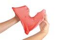 Hand trying to form heart shape from red slime toy