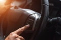 Hand tuning fm radio button in car panel Royalty Free Stock Photo