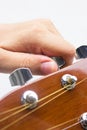 Hand tuning a guitar from headstock.