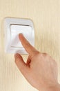 Hand turn off the light switch on the wall Royalty Free Stock Photo