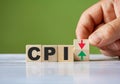 The hand turn wooden block with red and green arrow as change concept of CPI. Word CPI conceptual symbol Royalty Free Stock Photo