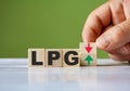 The hand turn wooden block with red and green arrow as change concept of LPG. Word LPG conceptual symbol Royalty Free Stock Photo