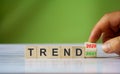 Hand turn wooden cube block and changes the word `Trend 2020` to `Trend 2021 Royalty Free Stock Photo