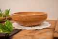 A hand-turned wooden bowl made of light pearwood with all-round decoration stands on a wooden board Royalty Free Stock Photo