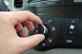 Hand turning a car Air Conditioning Heater knob