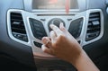Hand turning on car radio system