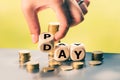 Hand is turning a dice and changes the word Pay to Day Royalty Free Stock Photo