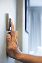 Hand is turning on a light switch in a house. Royalty Free Stock Photo