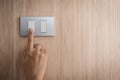 Hand turning on or off on grey light switch with wooden Royalty Free Stock Photo