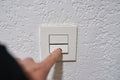 Hand turning off the light on a switch Royalty Free Stock Photo