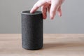 Hand turning off smart speaker microphone