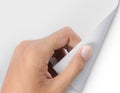 Hand turning page of white paper Royalty Free Stock Photo