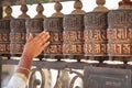 Hand turning prayer wheels at the Swayambhunath Stupa in Kathmandu Royalty Free Stock Photo