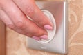 Hand turning wall light switch Royalty Free Stock Photo