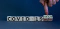Hand turns cubes and changes the expression `covid-19 myths` to `covid-19 facts`. Beautiful grey background. COVID-19 pandemic