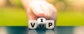 Hand turns dice and changes the acronym `VUP` very unimportant person to `VIP` very important person. Royalty Free Stock Photo