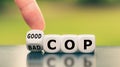 Hand turns a dice and changes the expression `bad cop` to `good cop`, or vice versa. Royalty Free Stock Photo