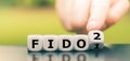 Hand turns a dice and changes the expression `FIDO1` to `FIDO2.