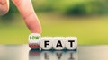 Hand turns a dice and changes the expression from `high fat` to `low fat. Royalty Free Stock Photo