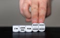 Hand turns dice and changes the expression `I am looking for hard work` to `I am looking for easy money`. Royalty Free Stock Photo